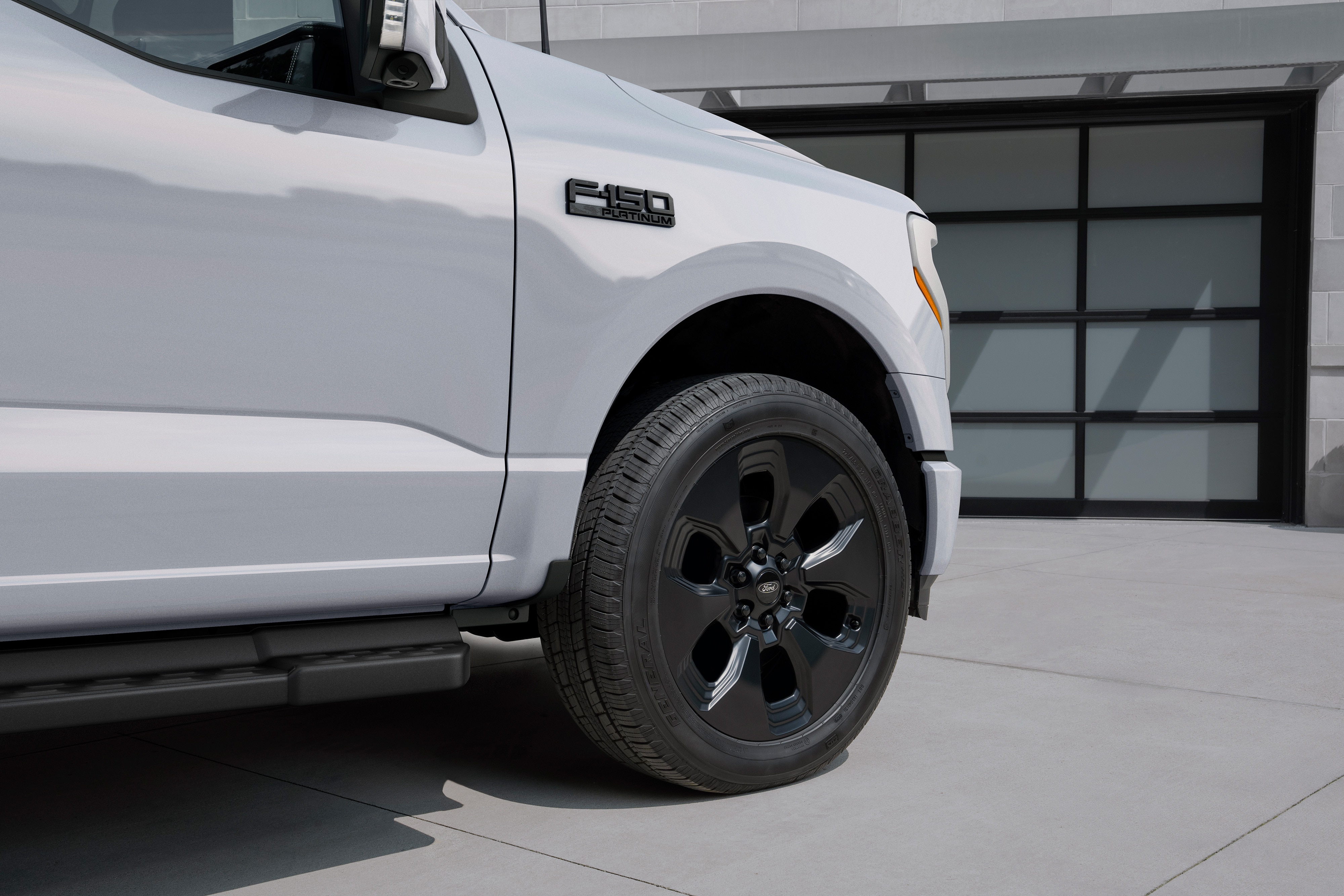 The 22-inch black painted wheels on the 2025 F-150® Lightning® Dark Elements package in Space White.
